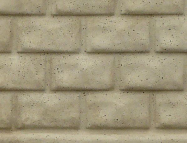 Concrete fence texture with a smooth, undamaged surface that is sculpted to appear as three sections of brick, with a thin column on either side.